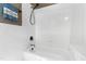 Clean, white tiled bathroom features a tub and shower, perfect for a bright and refreshing experience at 1329 Wynncrest Ct, Raleigh, NC 27603