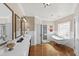 Luxurious bathroom featuring double sinks, elegant mirrors, and clawfoot soaking tub with a separate glass enclosed shower at 1329 Wynncrest Ct, Raleigh, NC 27603