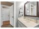 Bathroom vanity with a decorative mirror, neutral color scheme, and modern lighting fixtures at 1329 Wynncrest Ct, Raleigh, NC 27603