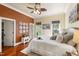 Comfortable bedroom features a decorative ceiling fan, multiple windows for natural light, and warm wall tones at 1329 Wynncrest Ct, Raleigh, NC 27603