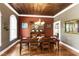Elegant dining room with a decorative tin ceiling and beautiful hardwood floors at 1329 Wynncrest Ct, Raleigh, NC 27603