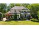 Charming two-story home with lush landscaping, dark shutters, and welcoming front entrance at 1329 Wynncrest Ct, Raleigh, NC 27603