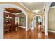 Hallway leading to dining room and stairs highlighting hardwood floors and architectural archways at 1329 Wynncrest Ct, Raleigh, NC 27603
