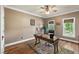 Bright home office featuring a wood floor, ceiling fan, natural lighting, and desk with a comfortable executive chair at 1329 Wynncrest Ct, Raleigh, NC 27603