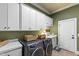 Functional laundry room with modern washer, dryer, and ample storage space at 1329 Wynncrest Ct, Raleigh, NC 27603