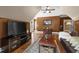 Upstairs living area with a TV, hardwood floors, vaulted ceilings, and a leather sofa at 1329 Wynncrest Ct, Raleigh, NC 27603