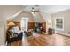 Cozy living room featuring a wood floor, ceiling fan, and seating area with a view from the arch window at 1329 Wynncrest Ct, Raleigh, NC 27603