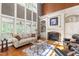 Bright living room featuring a fireplace, built-in shelves, and floor to ceiling windows at 1329 Wynncrest Ct, Raleigh, NC 27603