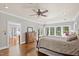 Spacious bedroom with hardwood floors, lots of natural light, and decorative ceiling fan at 1329 Wynncrest Ct, Raleigh, NC 27603