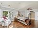 Relaxing bedroom with hardwood floors, seating area, natural light, and decorative ceiling fan at 1329 Wynncrest Ct, Raleigh, NC 27603