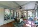 Relaxing screened porch with ceiling fan, wood floors and ceiling, and dining table perfect for outdoor meals at 1329 Wynncrest Ct, Raleigh, NC 27603