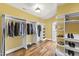 Spacious walk-in closet with custom shelving, wooden floors, and ample space for clothing and accessories at 1329 Wynncrest Ct, Raleigh, NC 27603