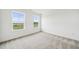 Neutral bedroom offers two large windows showcasing a scenic outdoor view at 149 Cribbs Ln, Middlesex, NC 27557