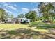 A sprawling backyard with a well-manicured lawn, framed by mature trees at 155 G Herring Rd, Princeton, NC 27569