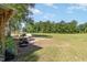 Spacious backyard and green grass on a sunny day at 155 G Herring Rd, Princeton, NC 27569