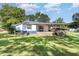 A well-maintained backyard with green grass and mature trees at 155 G Herring Rd, Princeton, NC 27569
