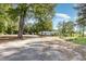 Gravel driveway leading to house and outbuilding, surrounded by mature trees at 155 G Herring Rd, Princeton, NC 27569
