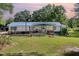 Quaint home featuring a covered front porch, blue accents and lush lawn at 155 G Herring Rd, Princeton, NC 27569
