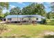 Quaint home featuring a covered front porch, blue accents and lush lawn at 155 G Herring Rd, Princeton, NC 27569