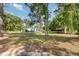 Charming home with a blue metal roof, nestled among mature trees and a spacious lawn at 155 G Herring Rd, Princeton, NC 27569