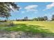 Expansive front yard featuring lush greenery, a large outbuilding, and ample space for various uses at 155 G Herring Rd, Princeton, NC 27569