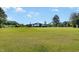 Wide view of the property featuring a large outbuilding and expansive, well-maintained lawn at 155 G Herring Rd, Princeton, NC 27569
