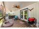 Inviting covered porch with ceiling fan, grill and comfortable seating at 155 G Herring Rd, Princeton, NC 27569