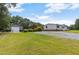 Expansive backyard featuring a detached garage, lush lawn, and mature trees at 165 Dawn Rd, Benson, NC 27504
