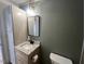 Bathroom featuring granite countertop, updated vanity, and storage tower at 165 Dawn Rd, Benson, NC 27504