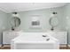 Relaxing bathroom showcasing a soaking tub, dual vanities, and modern fixtures at 165 Dawn Rd, Benson, NC 27504