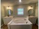 Bathroom features a large soaking tub flanked by two sink vanities at 165 Dawn Rd, Benson, NC 27504