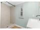 Clean bathroom featuring a tile shower, modern vanity, and window for natural light at 165 Dawn Rd, Benson, NC 27504