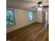 Bedroom featuring wood-look floors, a ceiling fan, and two windows at 165 Dawn Rd, Benson, NC 27504