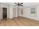 Large bedroom featuring wood-look floors, neutral walls, and bright windows at 165 Dawn Rd, Benson, NC 27504