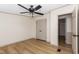 Bedroom with wood-look flooring, ceiling fan, and closet with double doors at 165 Dawn Rd, Benson, NC 27504