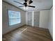 Bedroom showing wood-look floors, a ceiling fan, and two closets at 165 Dawn Rd, Benson, NC 27504