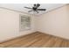 Spacious bedroom features wood-look flooring, a ceiling fan, and a window at 165 Dawn Rd, Benson, NC 27504