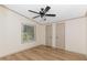 Bright bedroom boasts wood-look floors, ceiling fan, and closet with double doors at 165 Dawn Rd, Benson, NC 27504