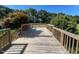 A wooden deck with railings overlooks the yard and trees at 165 Dawn Rd, Benson, NC 27504