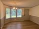 Cozy dining area offering a large window with ample light and an updated chandelier at 165 Dawn Rd, Benson, NC 27504