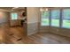 Bright dining area featuring a bay window with wooded views and updated flooring at 165 Dawn Rd, Benson, NC 27504