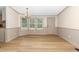 Inviting dining room with modern chandelier, wood-look flooring, and natural light at 165 Dawn Rd, Benson, NC 27504