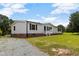 Beautiful one-story home with vinyl siding, brick foundation, and a gravel driveway at 165 Dawn Rd, Benson, NC 27504