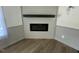 Close up on a modern electric fireplace with shiplap accents and wood-look flooring at 165 Dawn Rd, Benson, NC 27504
