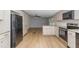 Bright kitchen boasting stainless steel appliances, granite counters, and wood-look flooring at 165 Dawn Rd, Benson, NC 27504