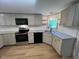 Well-lit kitchen with granite countertops, stainless steel appliances, and modern cabinetry at 165 Dawn Rd, Benson, NC 27504