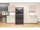 Functional kitchen showcasing stainless steel refrigerator and white cabinetry at 165 Dawn Rd, Benson, NC 27504