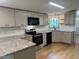 Modern kitchen featuring granite countertops, sleek appliances, and updated cabinetry at 165 Dawn Rd, Benson, NC 27504