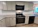 Modern kitchen featuring stainless steel appliances, granite countertops, and subway tile backsplash at 165 Dawn Rd, Benson, NC 27504