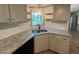 Stylish kitchen featuring granite counters, subway tile, stainless sink, and modern light fixture at 165 Dawn Rd, Benson, NC 27504